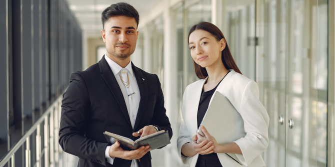 2 People 2 people in an office corridor looking at the camera