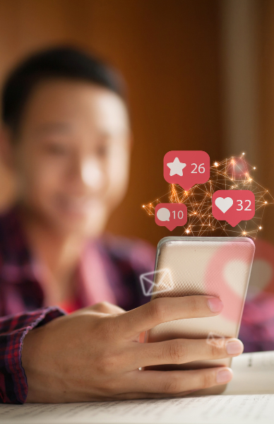 social media marketing training Man looking at a phone with social media icons floating above