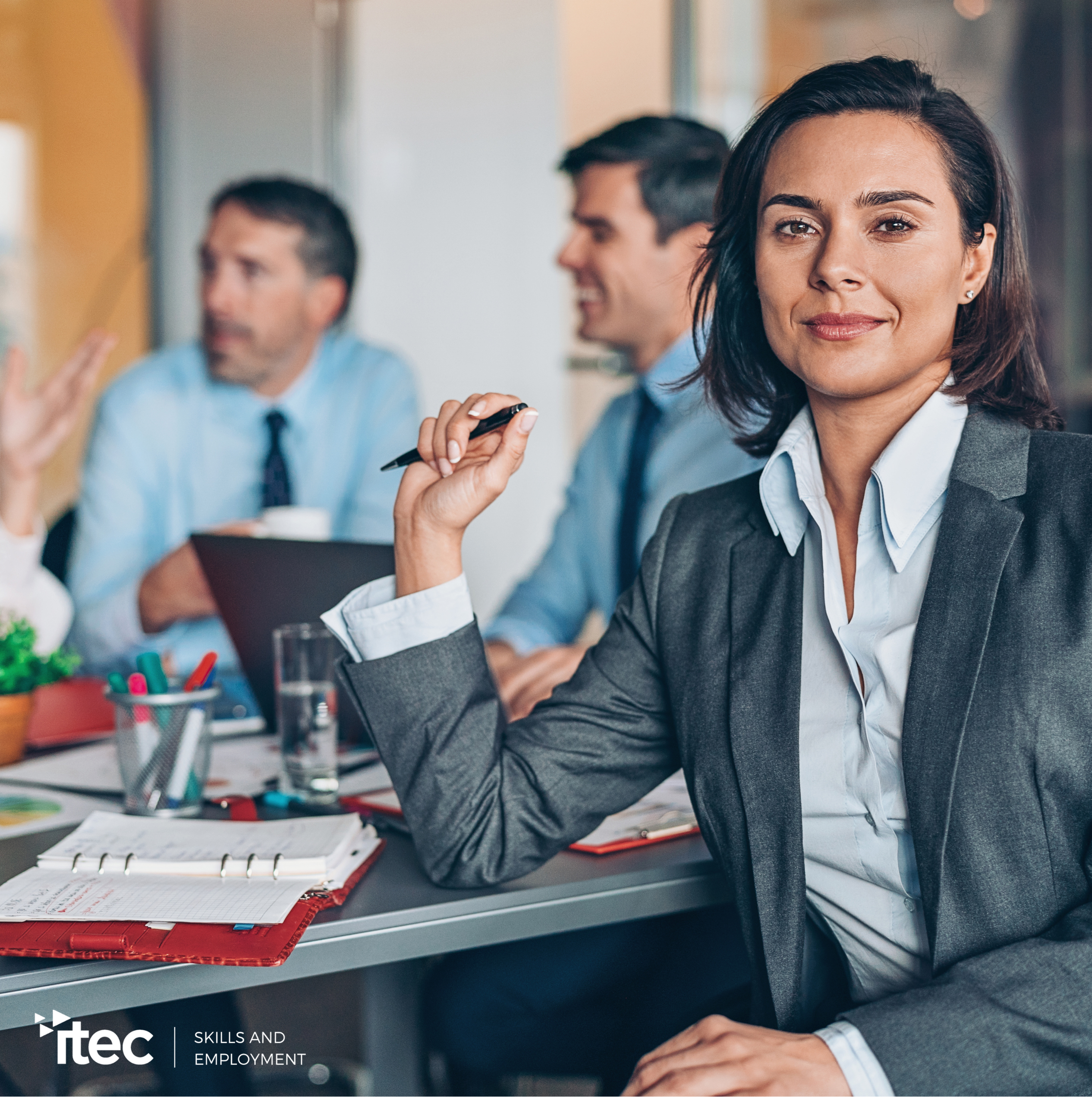 2 people in an office corridor looking at the camera